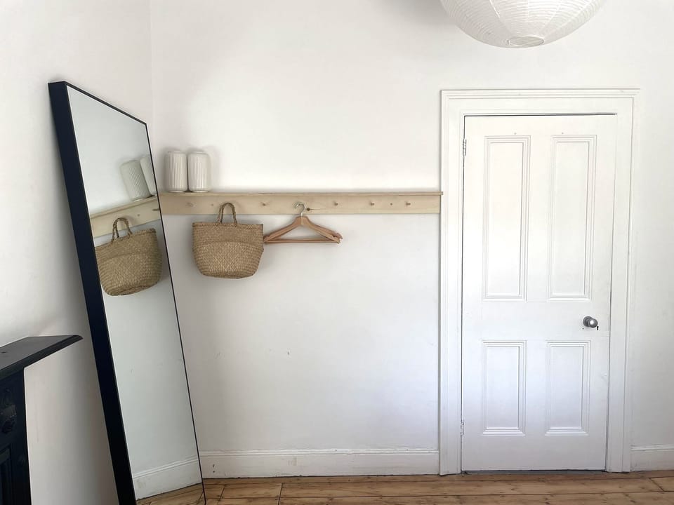 Double bedroom with full-length mirror and hanging storage