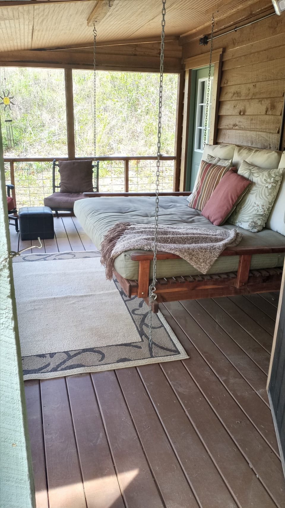 Full size swing bed on screened in back porch. Great space for glass of wine!