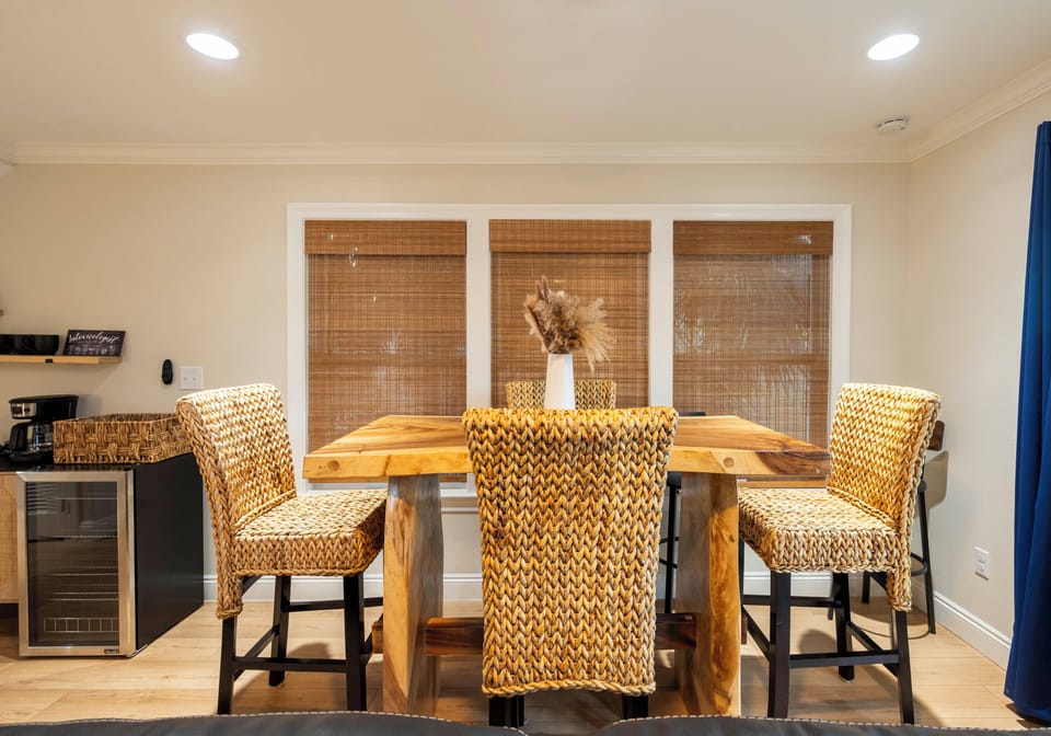 Cozy wicker chairs & rustic table for meals at "Bliss on the Bay," Gulf Shores.