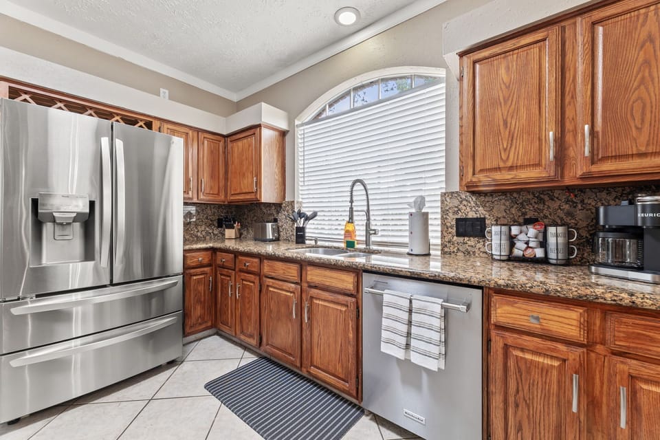 Fully equipped kitchen with modern appliances and Keurig coffee station.