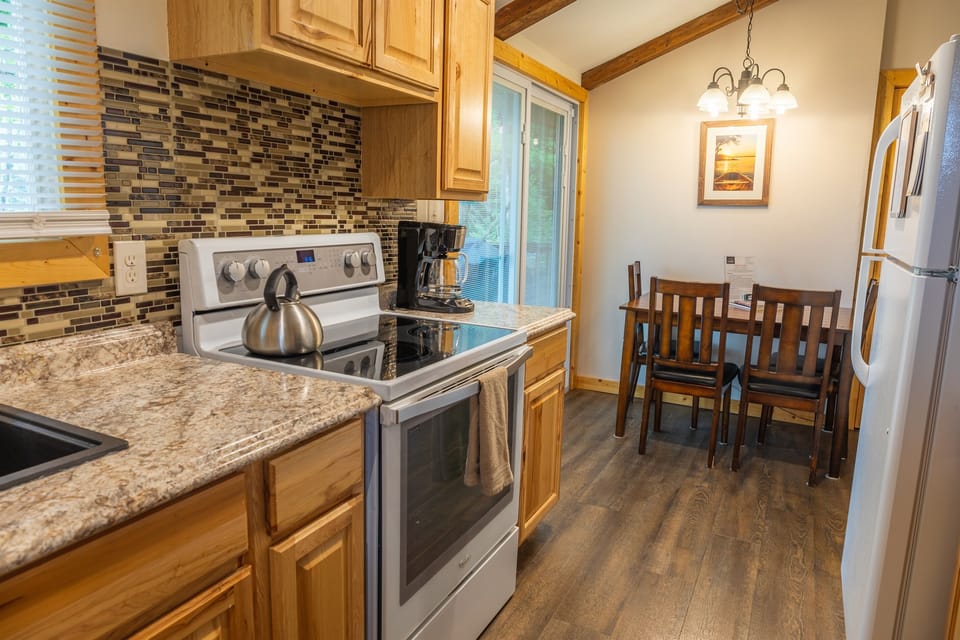 Upstairs kitchen and dining area with slider going to deck