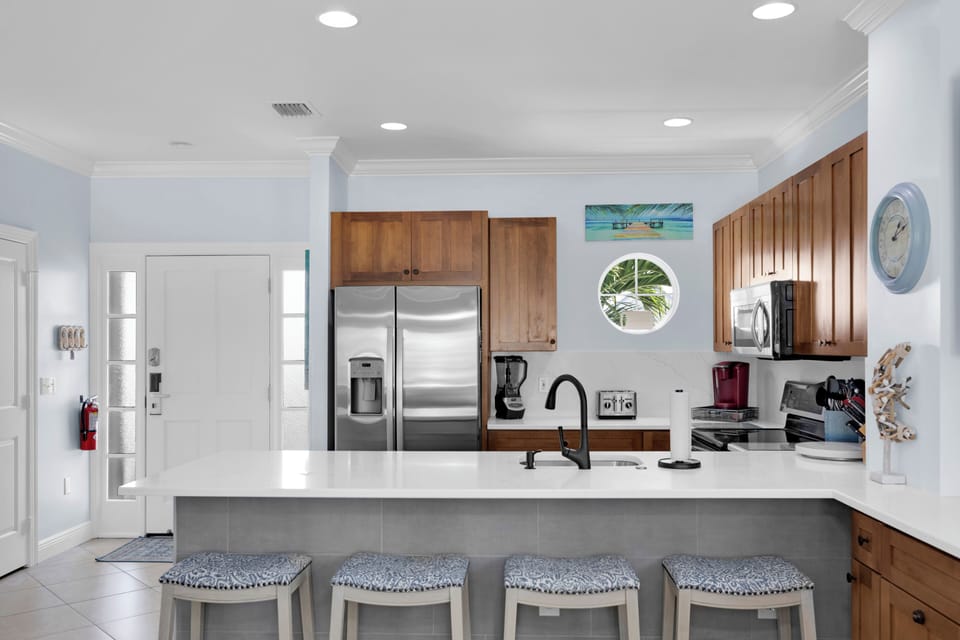Peninsula seating for 4 at the updated quartz counters.