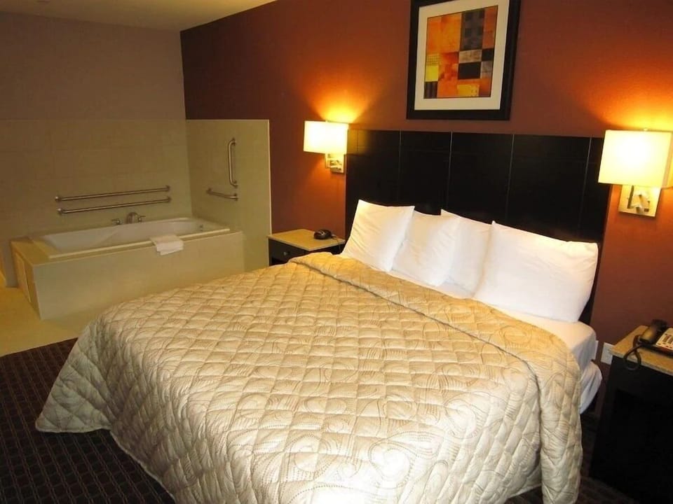Unwind in plush bedding beside your private soaking tub.