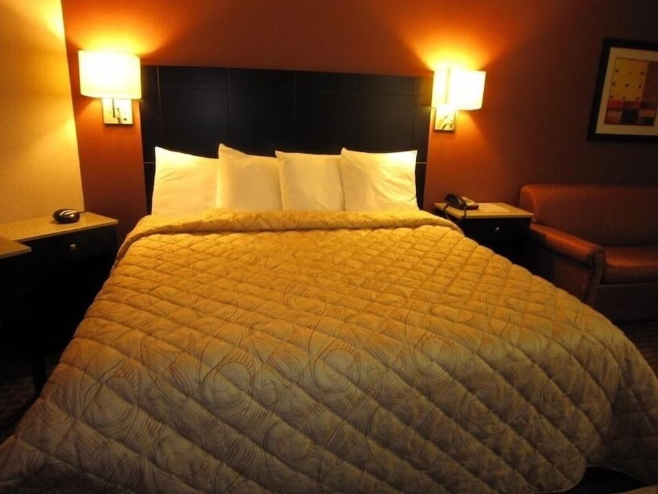 Drift off beneath glowing bedside lamps and plush pillows.