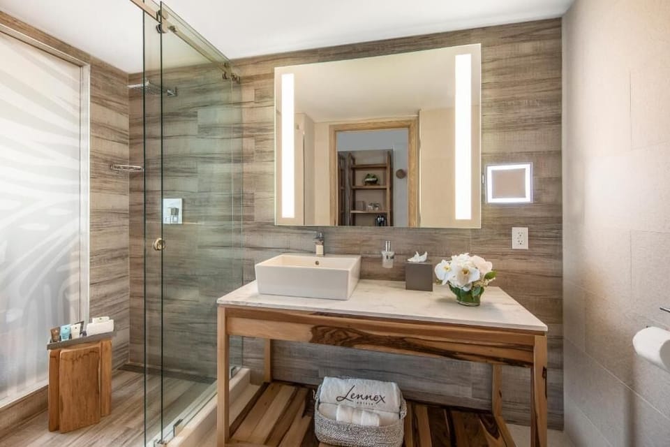 Refresh in a spa-like bathroom with glass walk-in shower.
