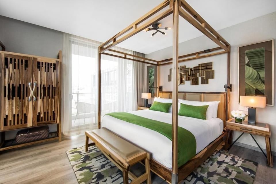 Unwind in a sunlit king bed with balcony views.