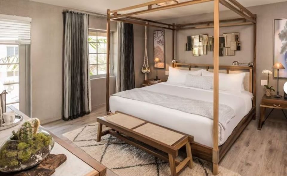 Escape into a statement canopy bed and serene, cozy textures.