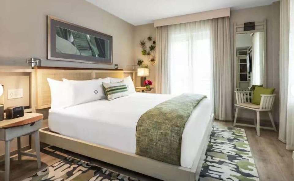 Drift off on a plush bed framed by soft, natural light.