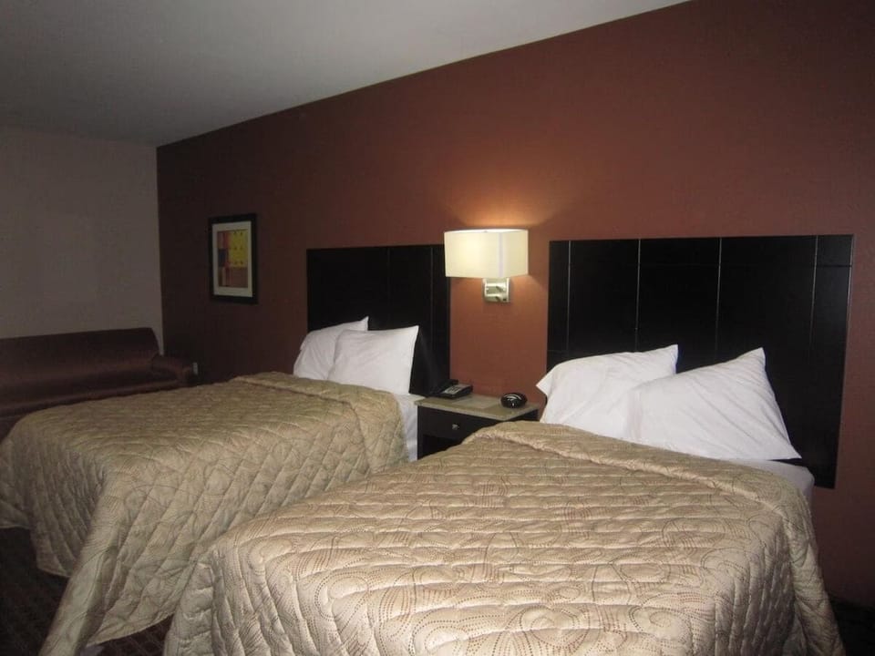 Drift off easily in crisp linens under soft bedside lighting.