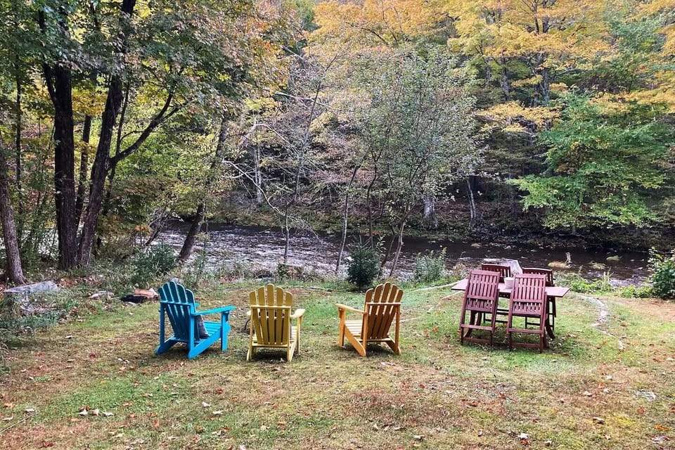 Side yard with fire pit and Adirondack chairs