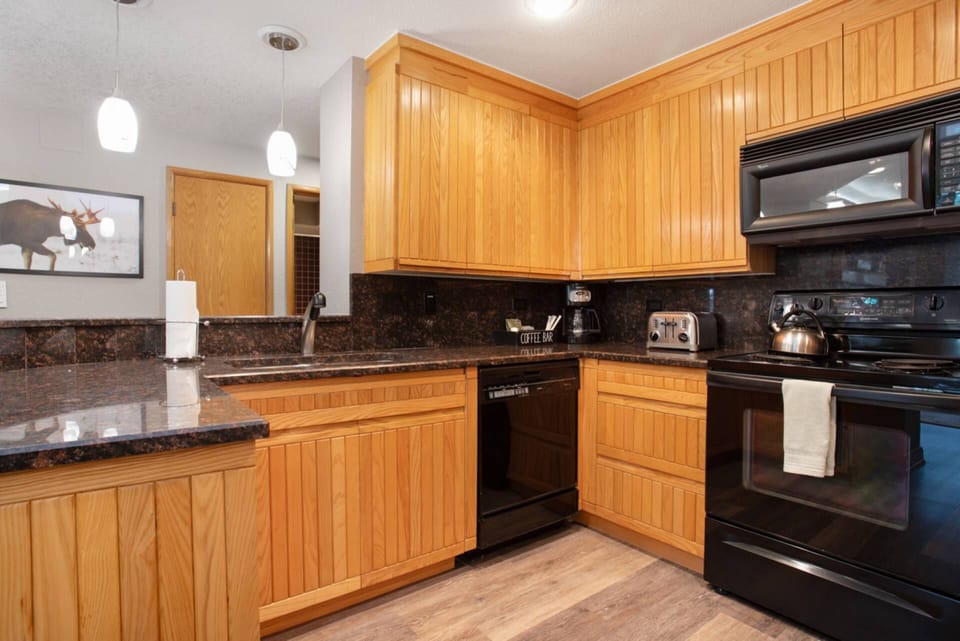 Kitchen features a Refrigerator, Dishwasher, Electric Range, Microwave and Fully Stocked Coffee Bar