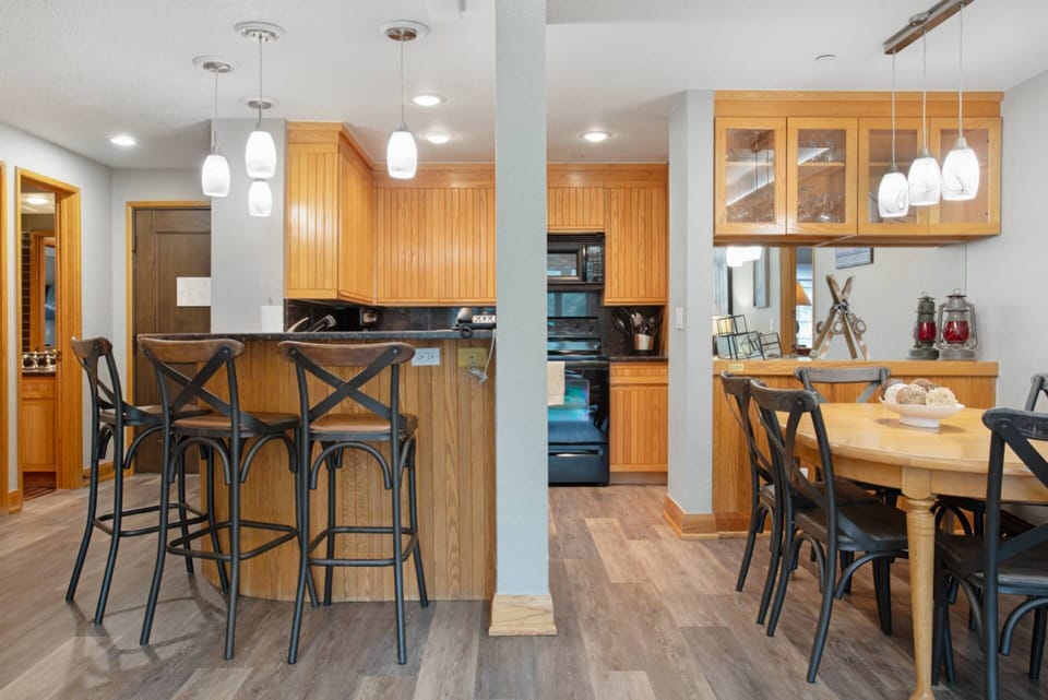 Kitchen with Bar Seating for 3 and Dining Room with Seating for 6.