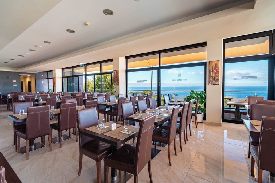 Dine leisurely in a bright restaurant overlooking the sparkling sea.