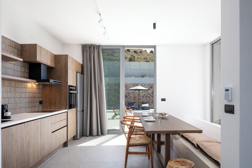 Οutdoor dining area for 8 guests under a shaded pergola