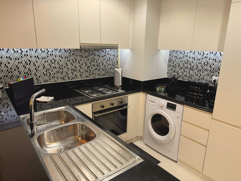 Fully equipped kitchen with washer/dryer, stove, oven, and Dishwasher