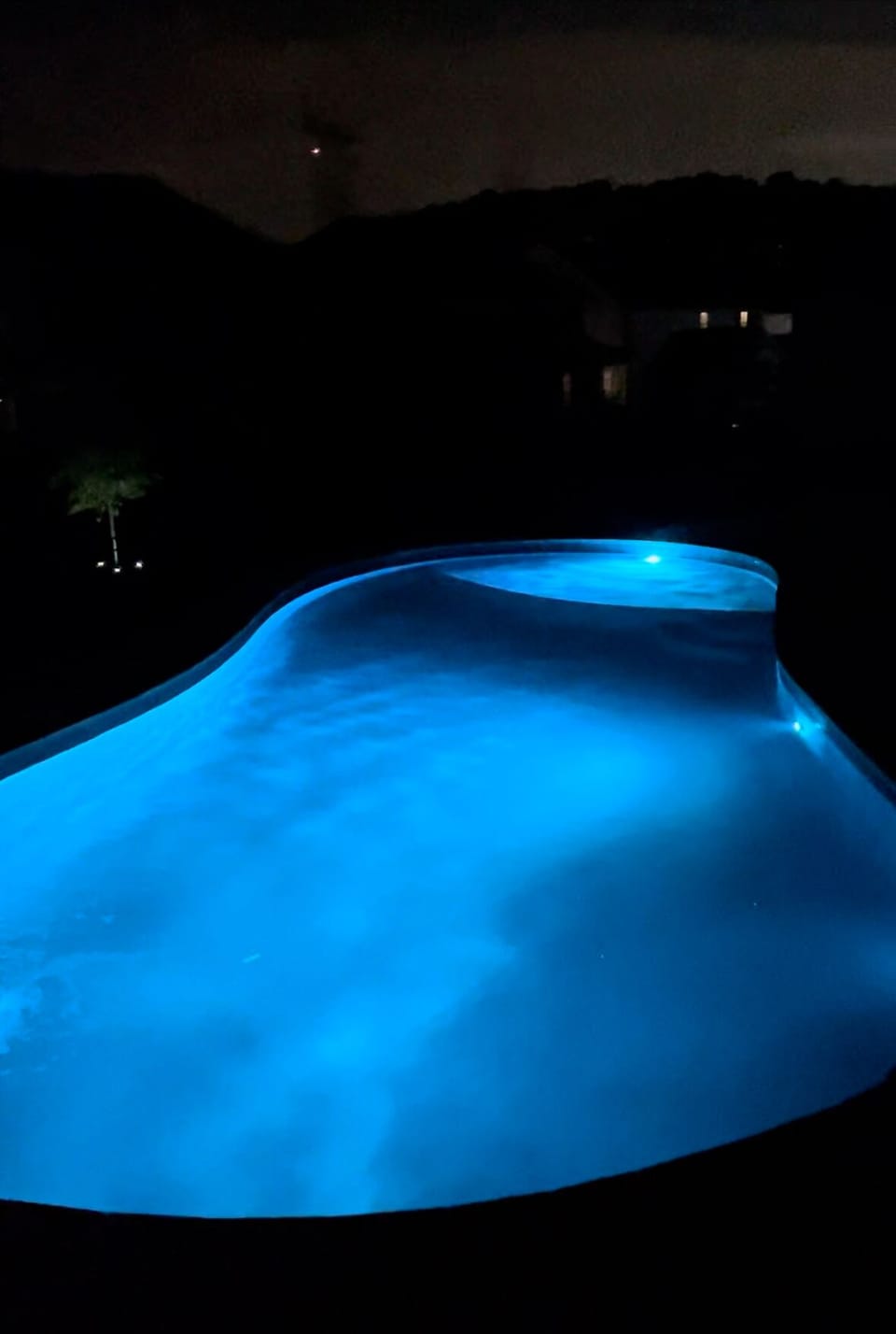 Pool at night with LED lights, remote control that allows you to change colors