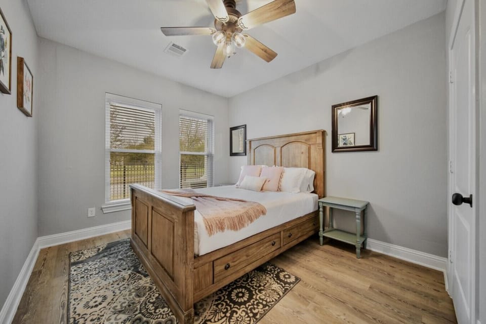 Discover peace and privacy in the third bedroom, featuring a queen-size bed with a view of the front of the property. It`s a cozy retreat where you can relax and enjoy a tranquil atmosphere during your stay.