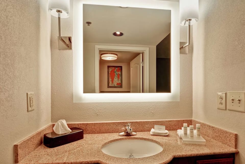 Freshen up easily with bright lighting and tidy amenities.