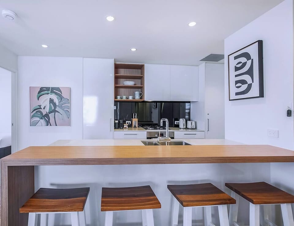 Take things slow up at the breakfast bar. The kitchen ensures plenty of space to prepare meals at home.