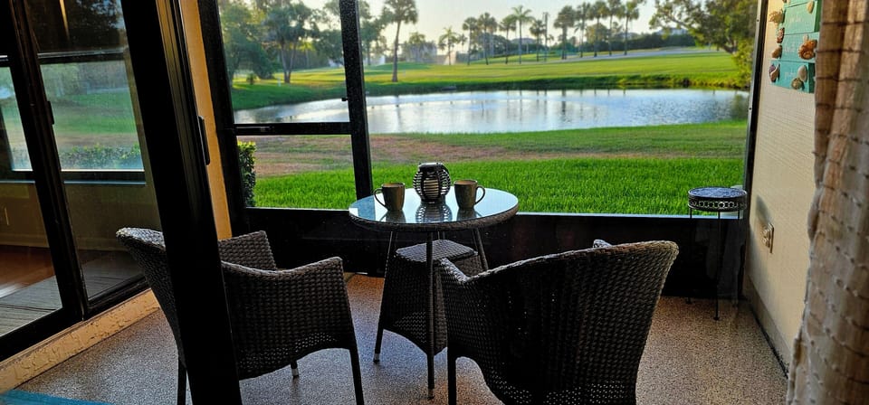 Enjoy morning coffee or evening cocktails in the screened in porch