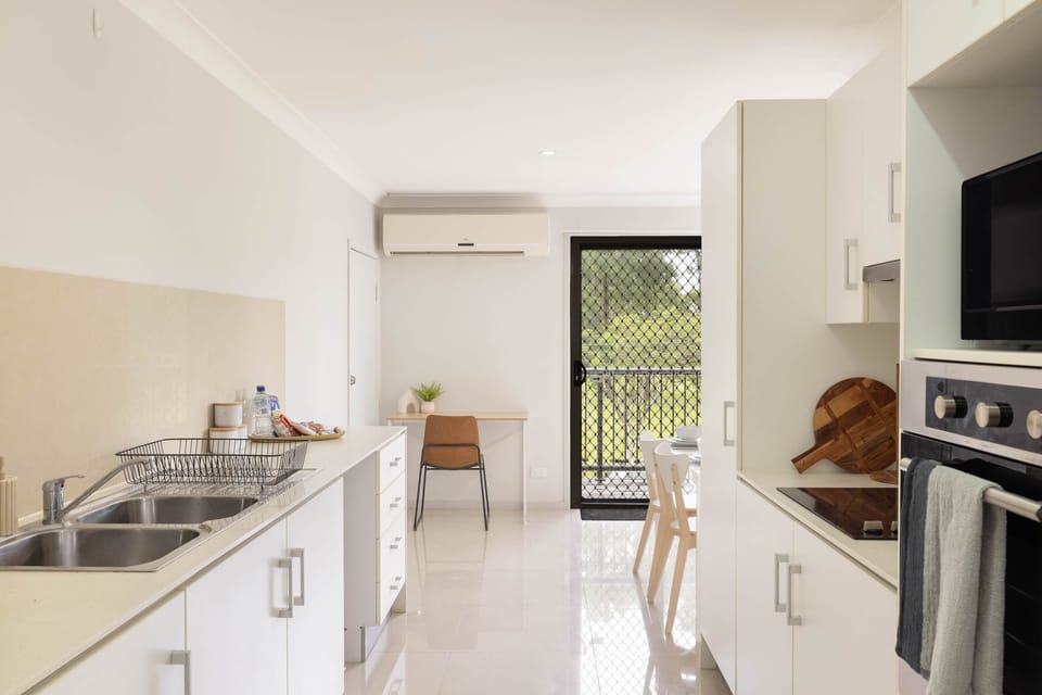 Kitchen: Sleek kitchen with ample storage, modern appliances