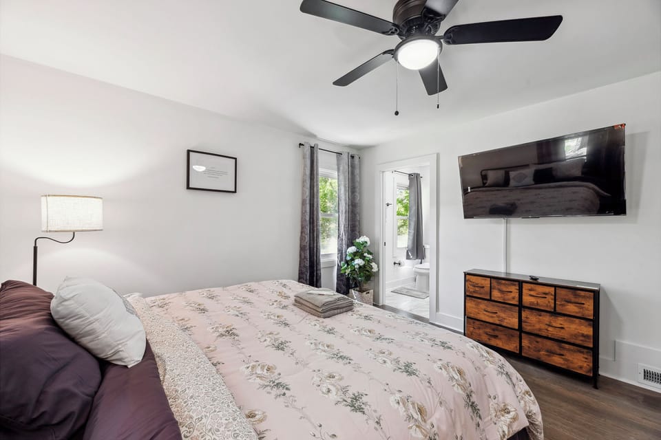 Enjoy restful comfort in our serene king-size bedroom with a smart TV.