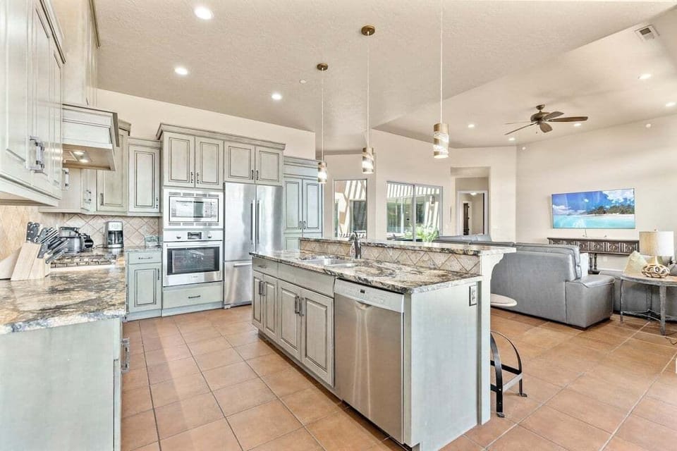 The main living area of the house consists of the Kitchen, Dining Room, and Living Room. The home's interiors are dressed traditionally and highlight features of the surrounding desertscape.