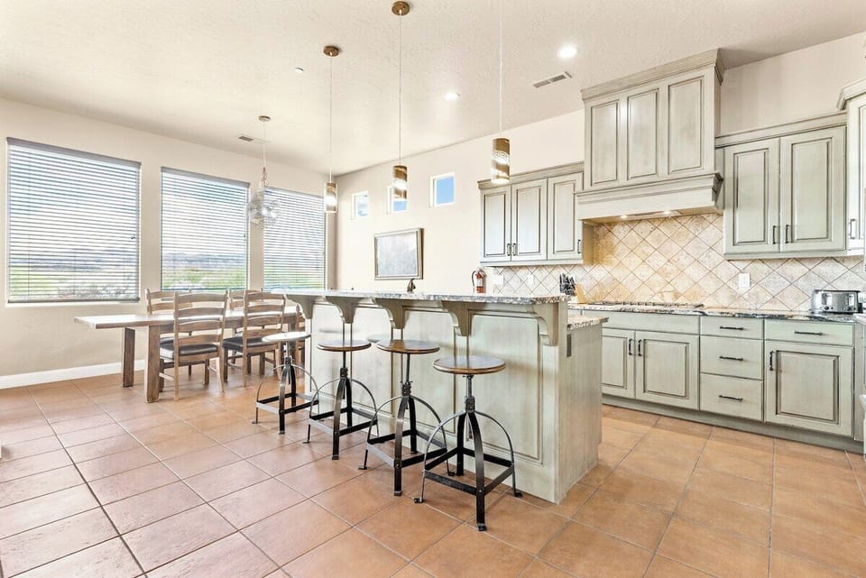 This spacious kitchen is fully stocked with modern appliances, cookware, and utensils, making it easy to prepare your favorite meals. Enjoy the open layout and various dining options for eventful gatherings.