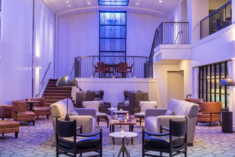 Enter Hotel Theodore's lobby: plush seating and ambient lighting for meetings or tranquil relaxation