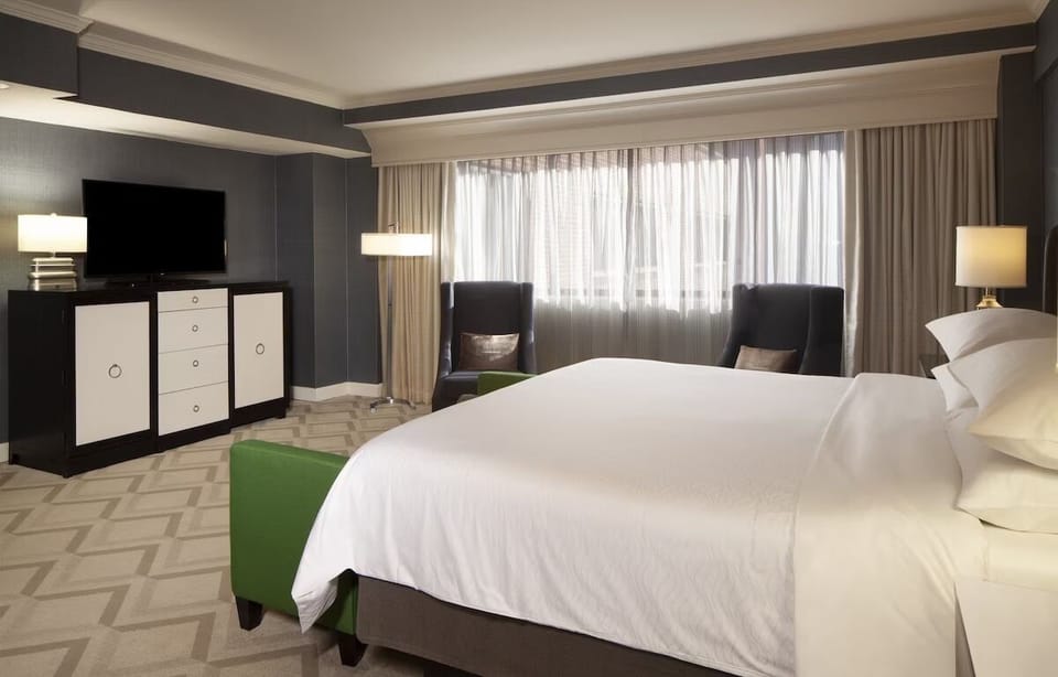 Relax in a spacious room with soft daylight and seating.
