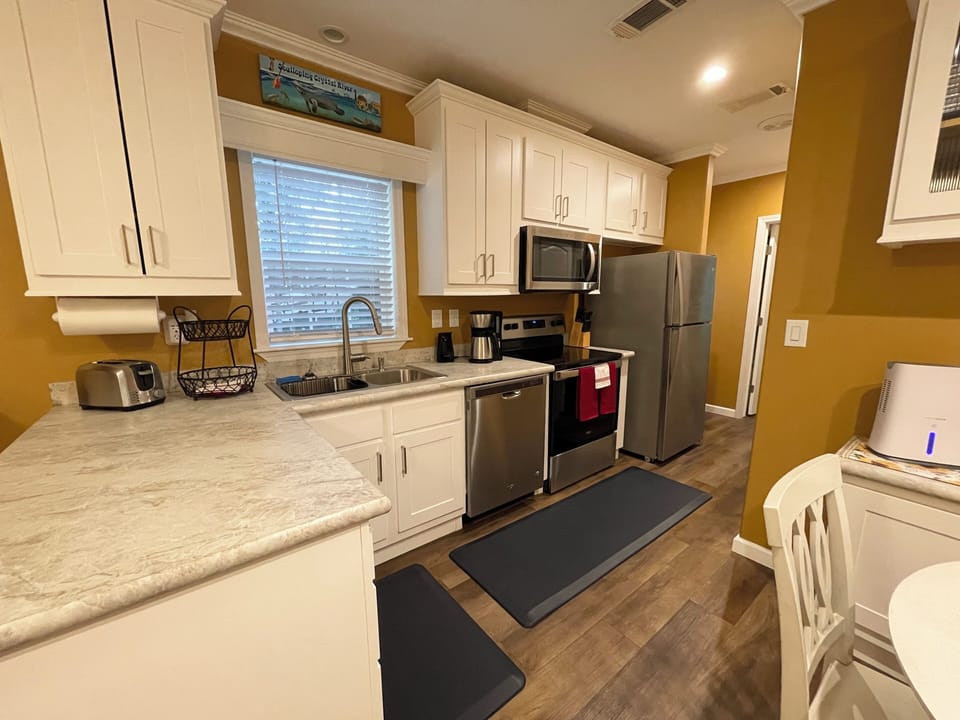 All stainless Whirlpool appliances and anti fatigue rugs.