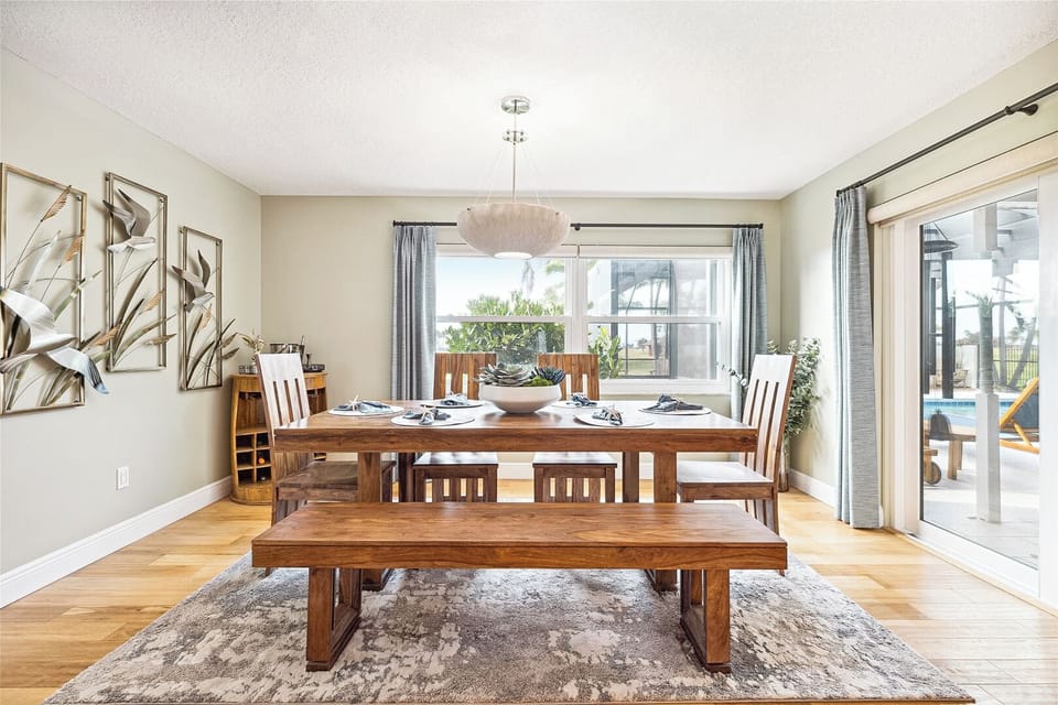 Gather around the stylish dining area with a four-seater table and a cozy bench