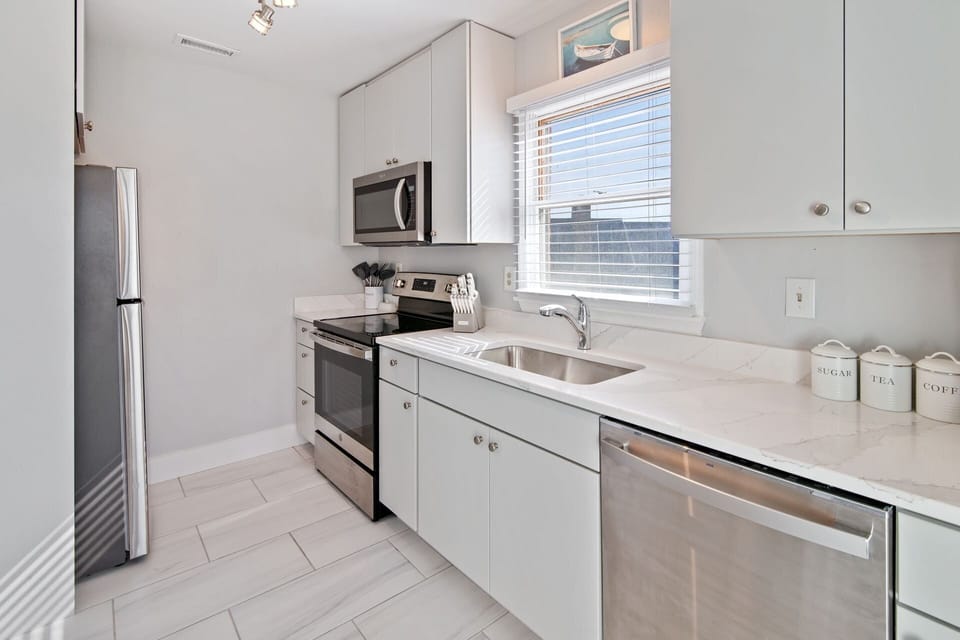The modern kitchen is complete with stainless steel appliances.