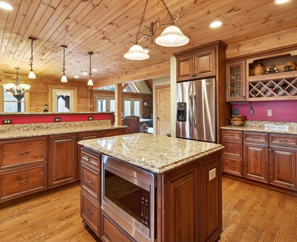 Fully equipped kitchen with island seating for 4, dining for 8, dishwasher, and two types of coffee makers (standard drip-style and Keurig)