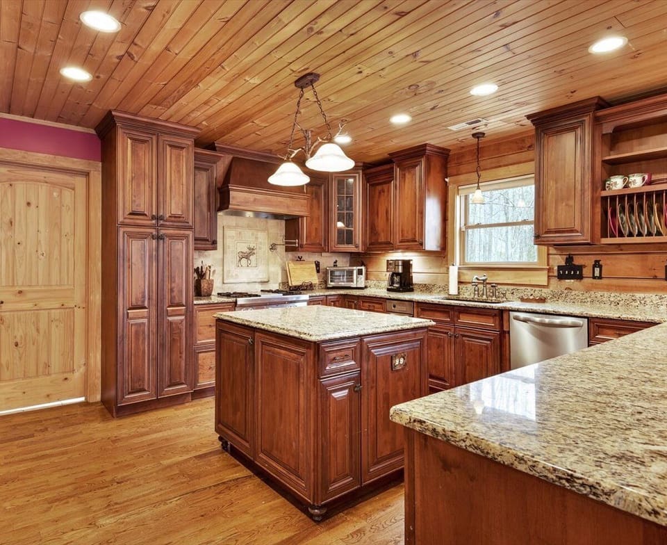 Fully equipped kitchen with island seating for 4, dining for 8, dishwasher, and two types of coffee makers (standard drip-style and Keurig)