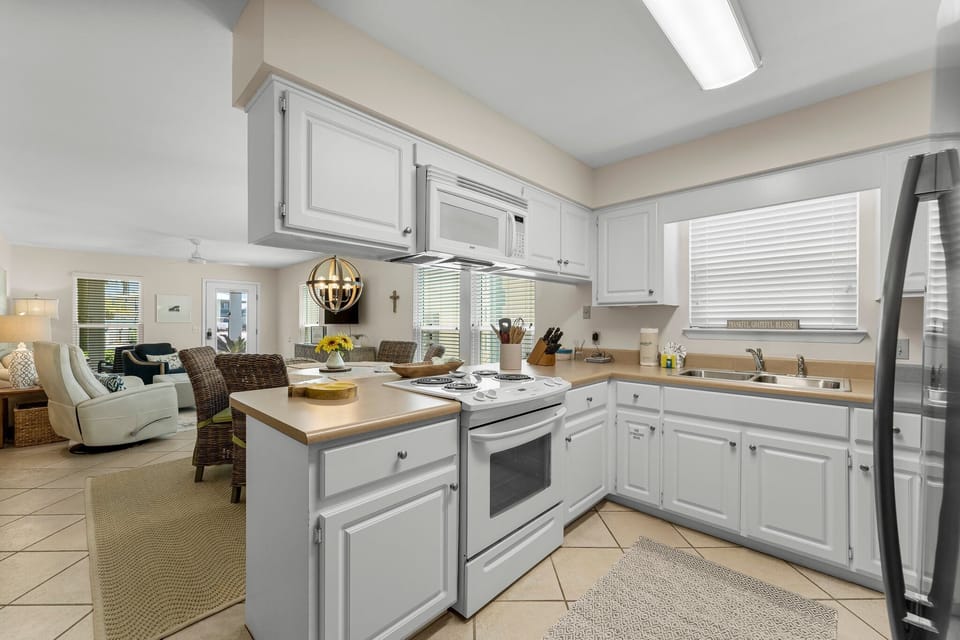 The kitchen's open layout allows for easy interaction, ensuring you never miss a moment of family time while cooking.