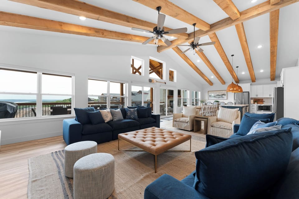 A grand open concept living space with rustic wood beams!