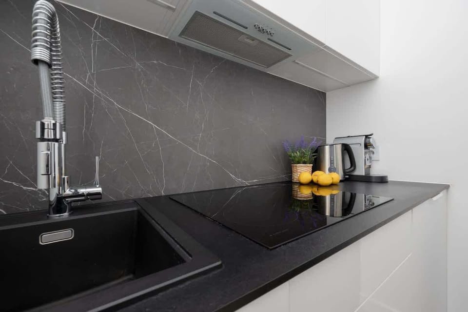 The sleek design of the kitchenette blending seamlessly with the living area.