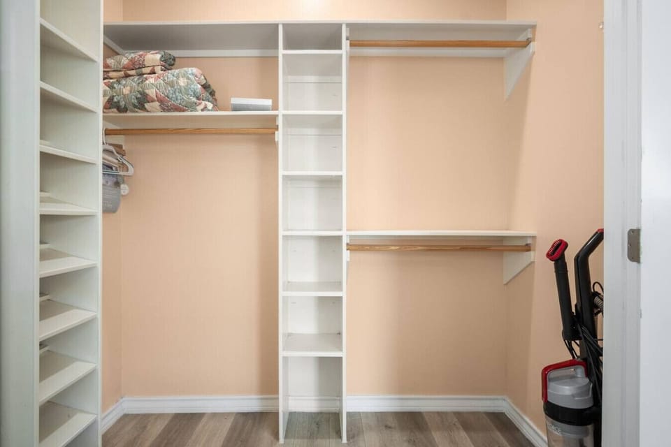 Spacious walk-in closet with shelving and storage.