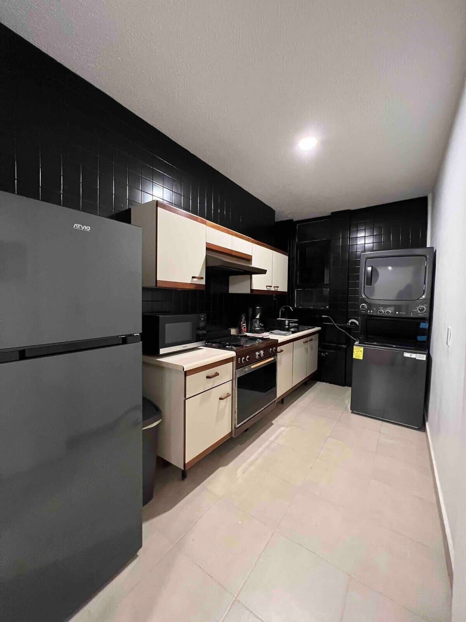 Convenient stacked washer & dryer located in the kitchen.
