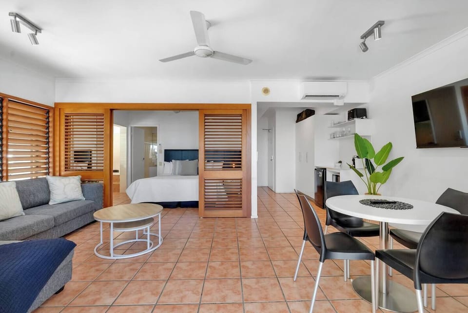 The apartment features ample seating, including a dining table for enjoying meals or working on your laptop.