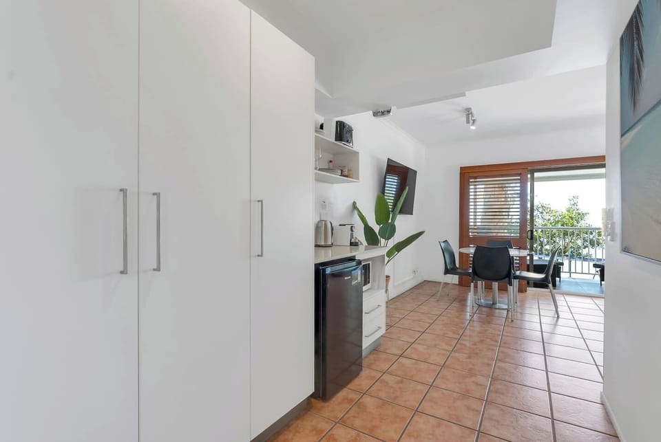 The compact kitchenette is fully equipped for your convenience, including a coffee machine, making it easy to prepare quick bites before heading out to explore Palm Cove.