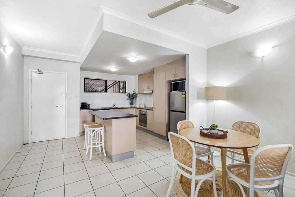 A trendy dining table plus stools at the breakfast bar make it easy for guests to come together for a shared meal at home.
