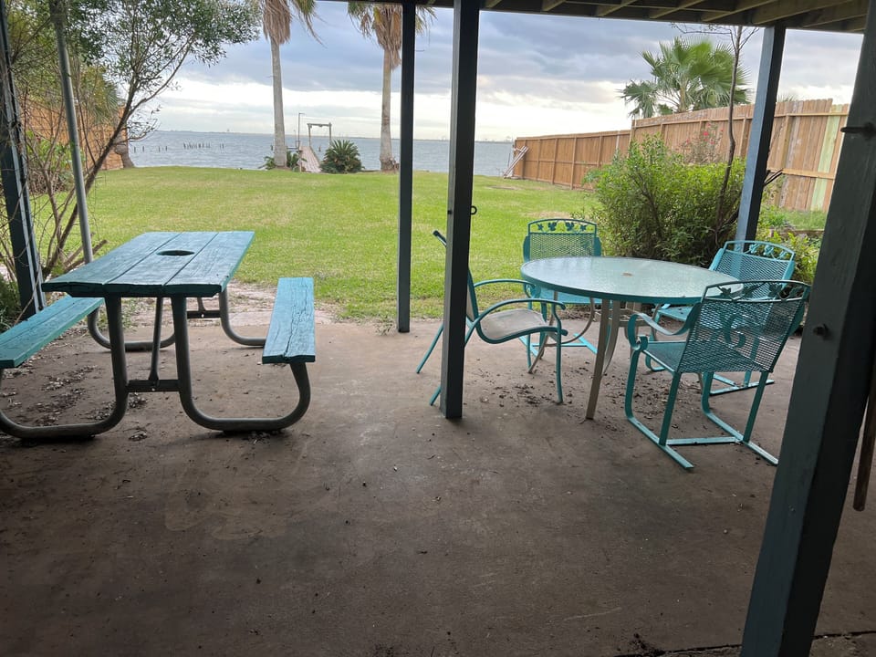 Outside sitting area includes picnic table table and four chairs and patio bar
