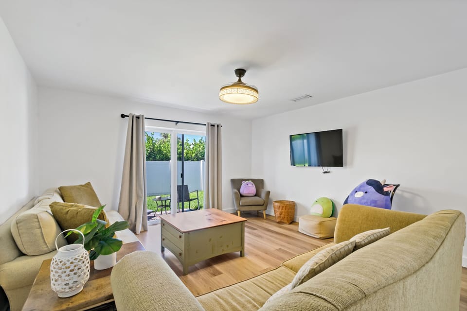 Smart TV. Great room style living room opens to kitchen.
Doors lead to backyard.