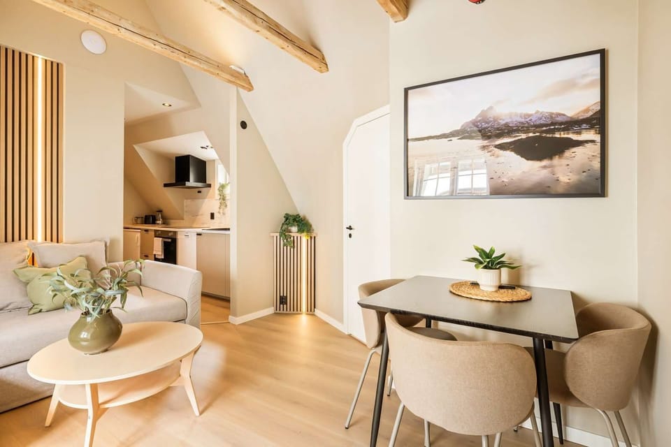 Bright open-plan living and dining area with Scandinavian-inspired decor and exposed beams