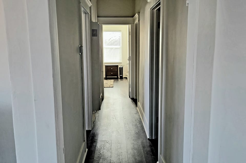 Main hallway leading to hall bath, laundry room and primary bedroom
