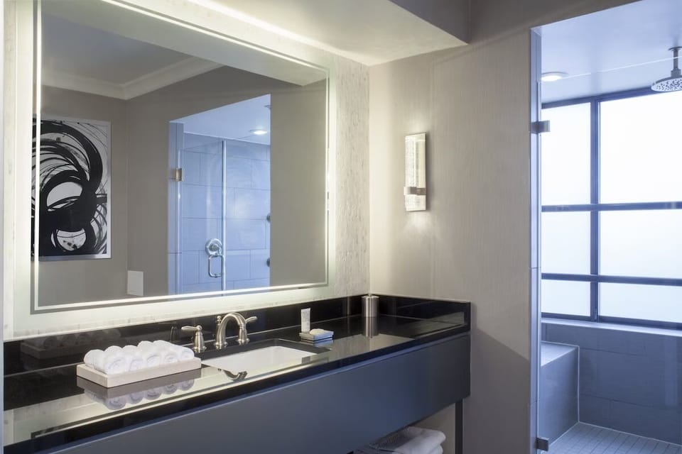 Refresh at the sleek vanity with bright mirror lighting.