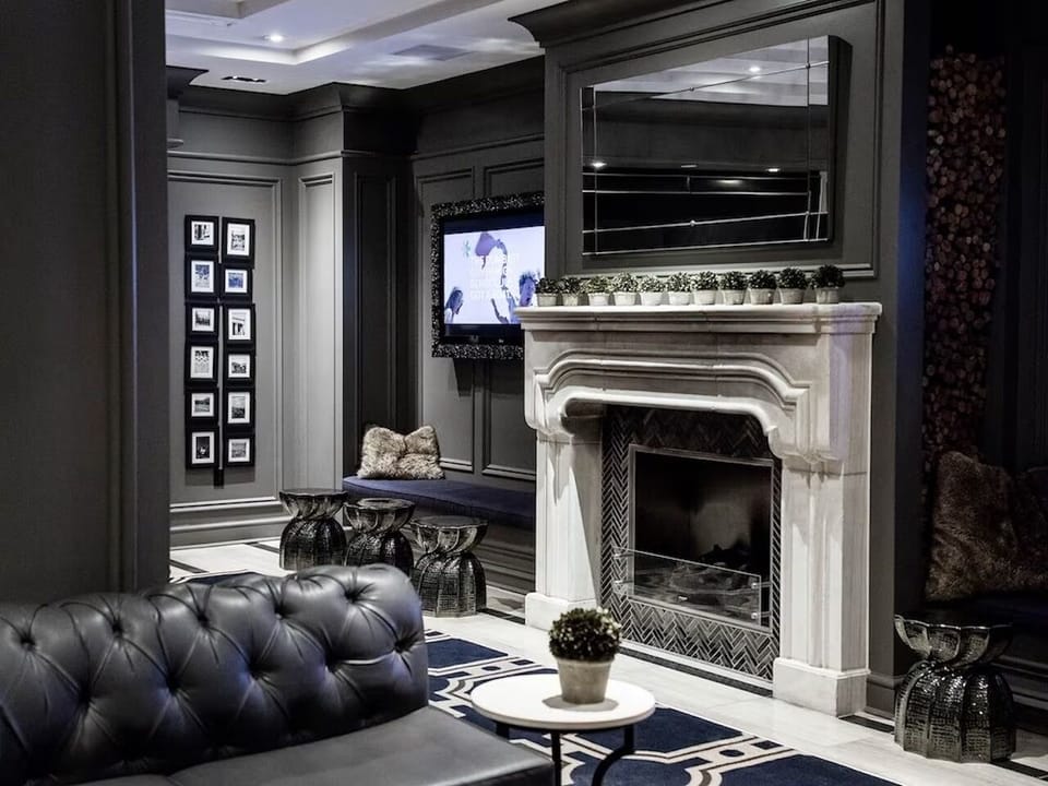 Sip and relax beside the grand marble hearth and lounge seating.