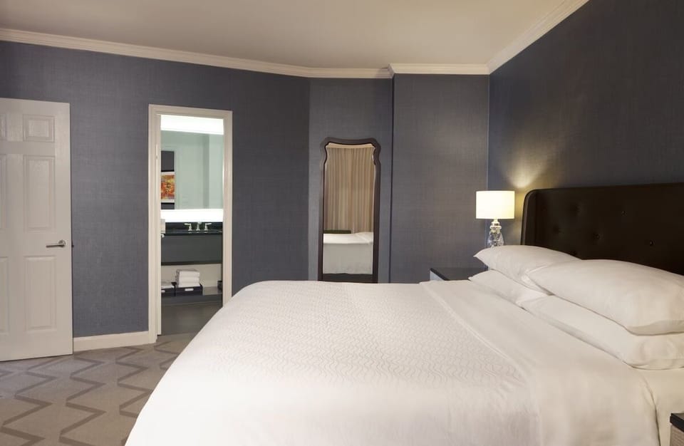 Sink into crisp linens in a calm, quiet bedroom retreat.